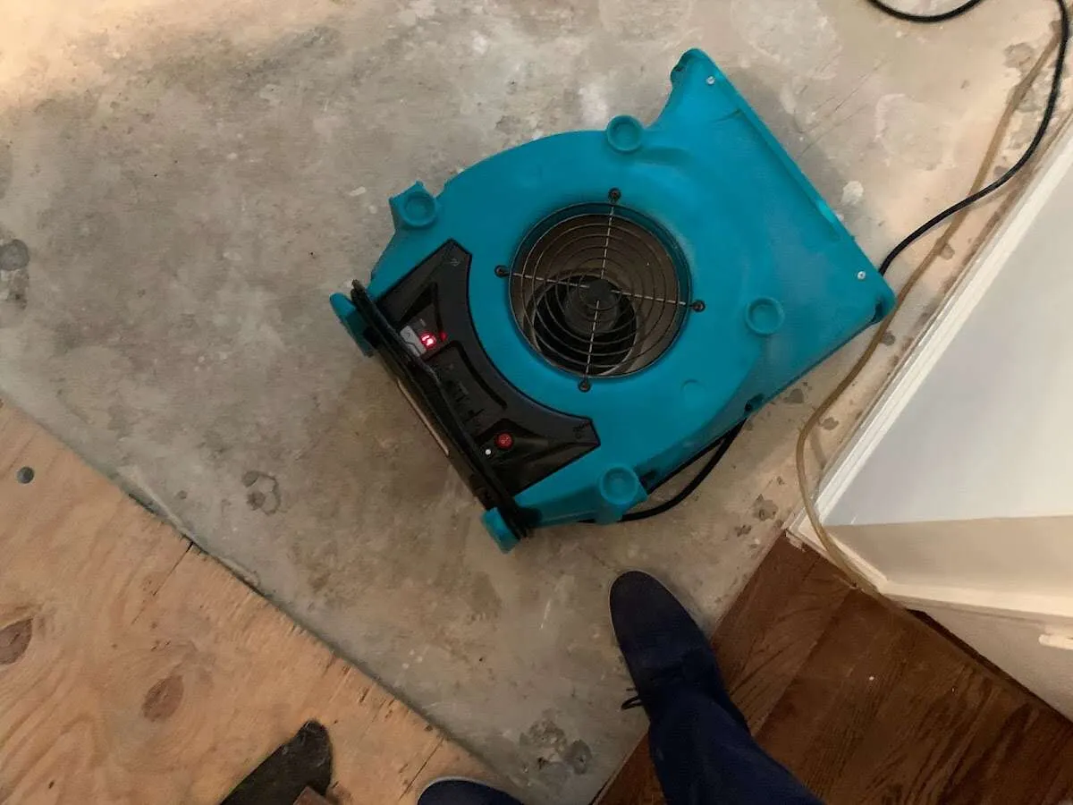 Air mover drying subfloor during Commercial Water Damage Restoration in Waite Park